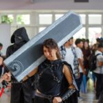 Cosplayer carries a large sword at an event