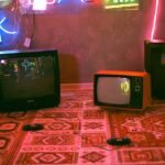 black crt tv on red and white floral textile